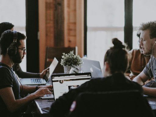 selective focus photography of people sits in front of table inside room
