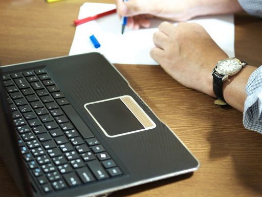 Zelfstandige aan bureau met stapel bonnetjes en facturen