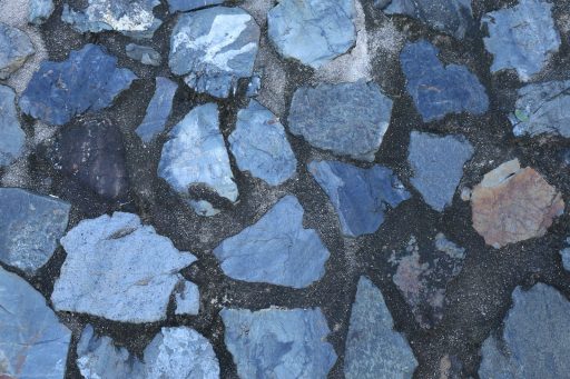 Blue stones embedded in dark cement