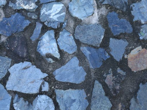 Blue stones embedded in dark cement